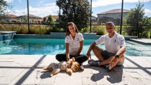 Fabio, Cristiano and a dog seated in front of a client's pool to fill the web page about us
